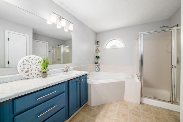 bathroom featuring vanity, separate shower and tub, tile patterned floors, and a textured ceiling