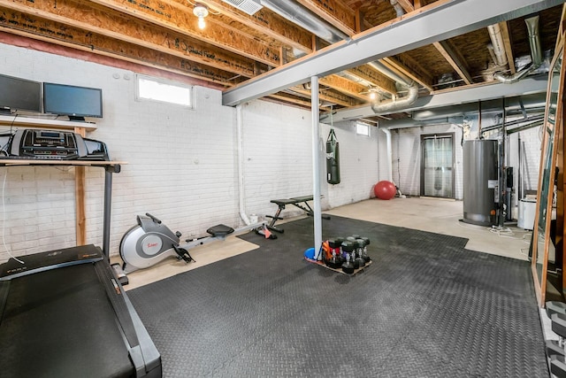 workout area with water heater and brick wall