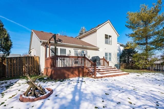 snow covered property featuring a wooden deck and central air condition unit