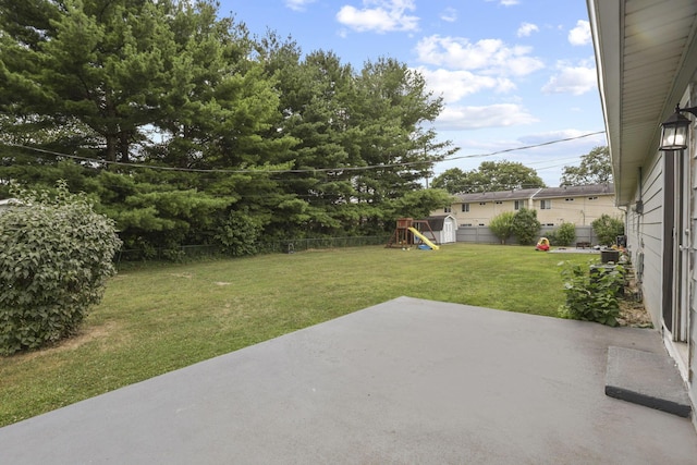 view of yard with a playground and a patio