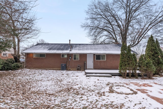 snow covered property featuring cooling unit