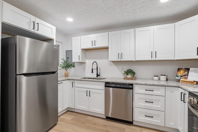 kitchen with appliances with stainless steel finishes and white cabinets