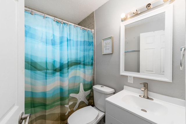 bathroom with vanity, toilet, a textured ceiling, and walk in shower