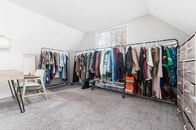 walk in closet with lofted ceiling and carpet flooring