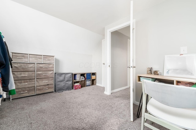 bedroom featuring lofted ceiling and light carpet