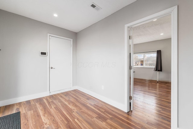 spare room with wood-type flooring