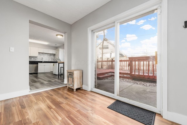 entryway with sink and light hardwood / wood-style floors