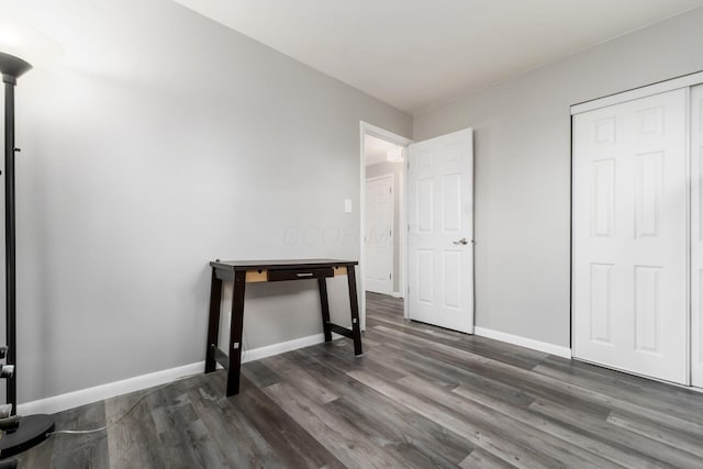 bedroom with a closet and dark hardwood / wood-style floors