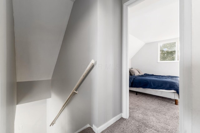 carpeted bedroom featuring vaulted ceiling