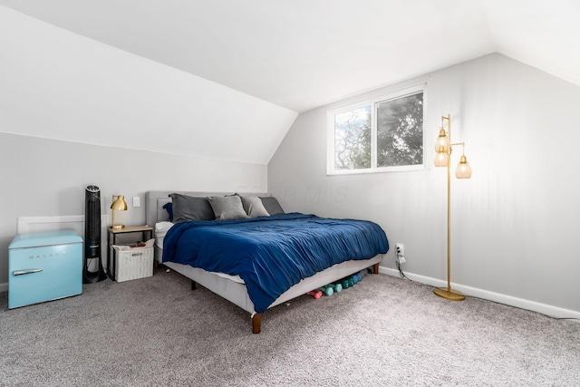 bedroom with vaulted ceiling and carpet