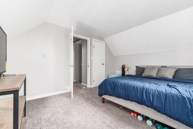 bedroom featuring lofted ceiling and carpet