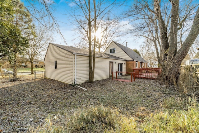 rear view of house featuring a wooden deck