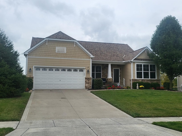 craftsman-style home with a garage and a front lawn