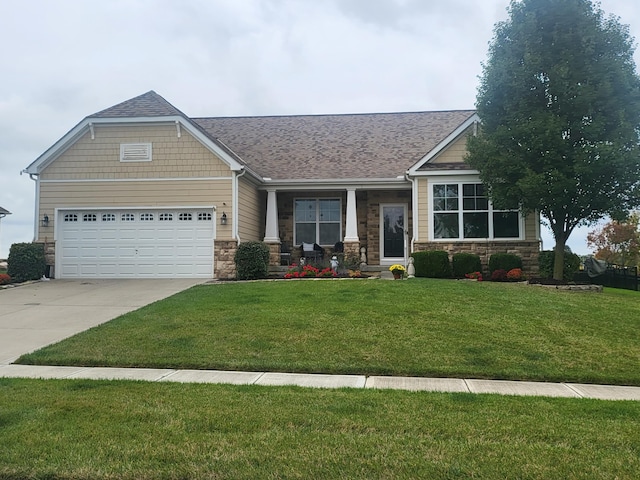 craftsman-style house featuring a garage and a front lawn