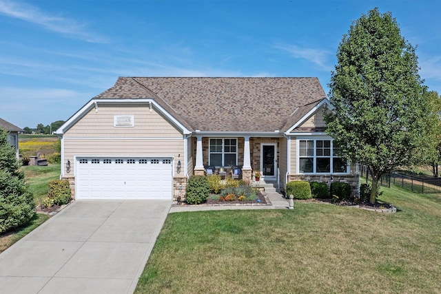 view of front of property with a porch, a garage, and a front lawn