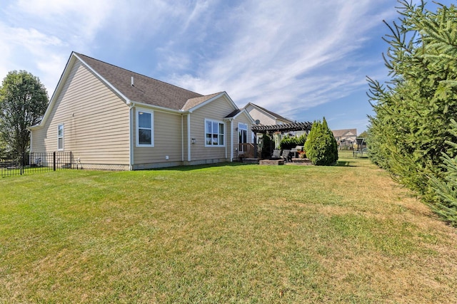 back of property featuring a pergola and a lawn