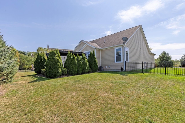 view of home's exterior featuring central AC unit and a lawn