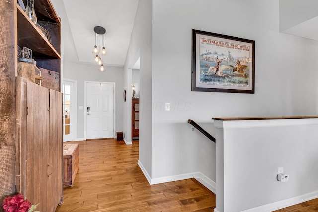 entrance foyer featuring vaulted ceiling and light wood-type flooring