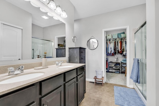 bathroom featuring vanity, tile patterned floors, and a shower with shower door