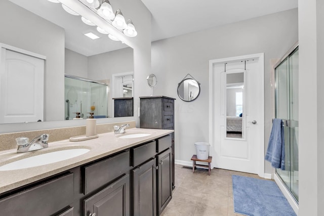 bathroom featuring vanity, tile patterned floors, and a shower with shower door