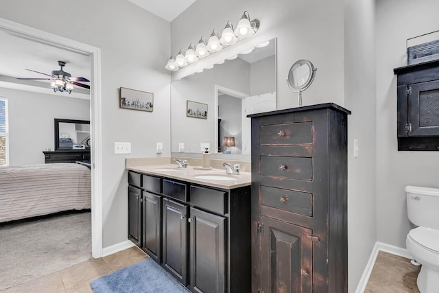 bathroom featuring tile patterned flooring, vanity, ceiling fan, and toilet