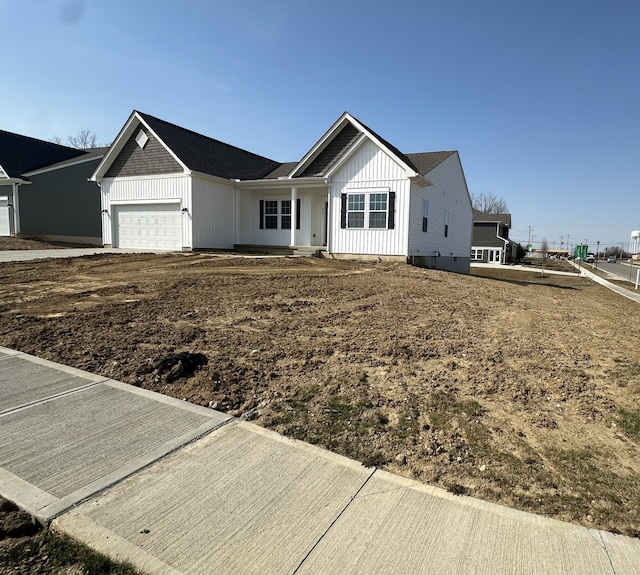 ranch-style house with a garage and board and batten siding