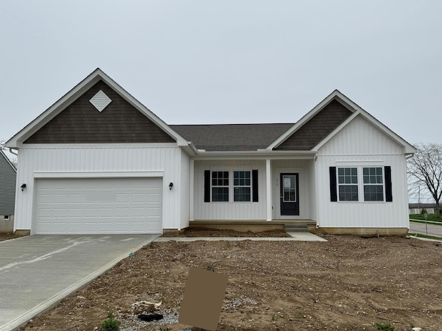 view of front of house featuring driveway, an attached garage, and board and batten siding