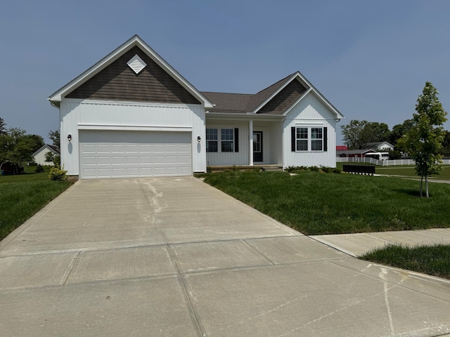 450 Creekside Dr, Commercial Point, OH 43116 - ranch-style house with concrete driveway, a front yard, and a garage
