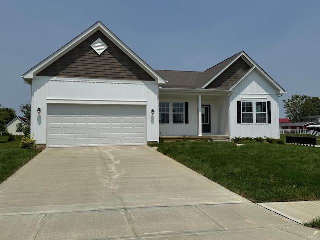 450 Creekside Dr, Commercial Point, OH 43116 - ranch-style home featuring driveway, a front yard, an attached garage, and covered porch