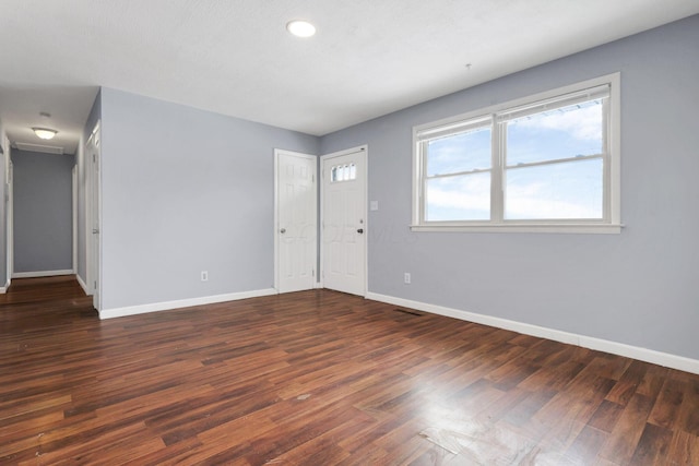 empty room featuring dark hardwood / wood-style flooring