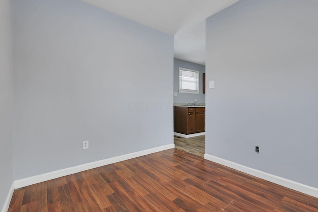 spare room featuring dark hardwood / wood-style flooring