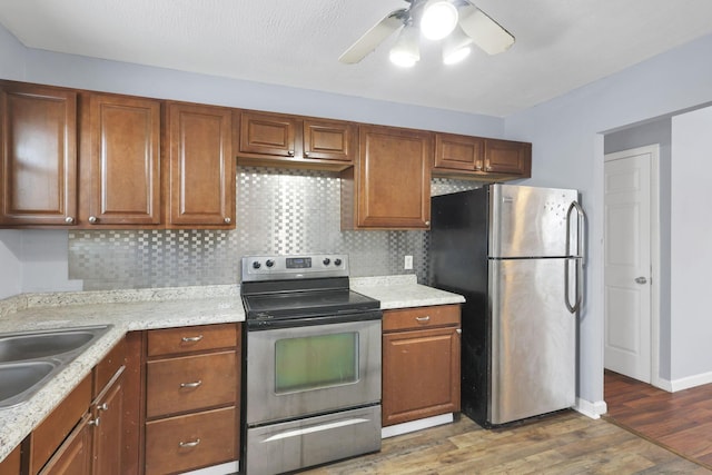 kitchen featuring appliances with stainless steel finishes, dark hardwood / wood-style floors, sink, and decorative backsplash