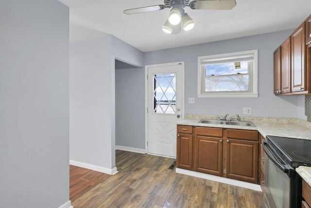 kitchen with dark hardwood / wood-style flooring, sink, black range with electric stovetop, and ceiling fan