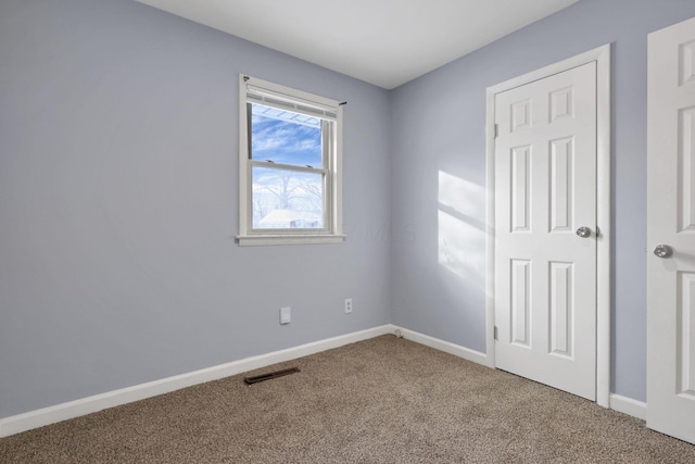 empty room with carpet flooring