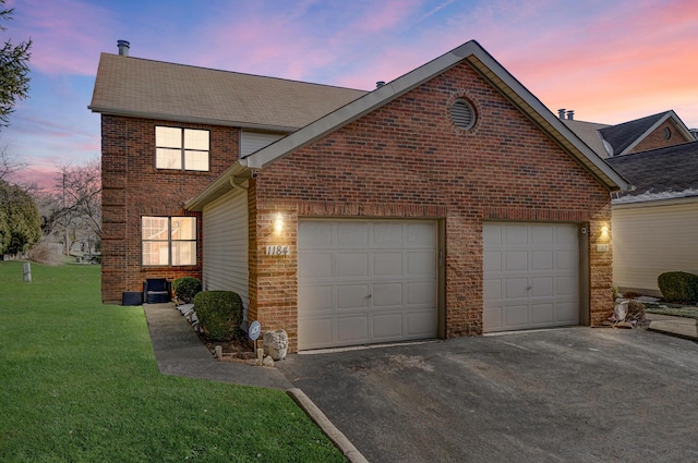 view of front of home featuring a garage and a lawn