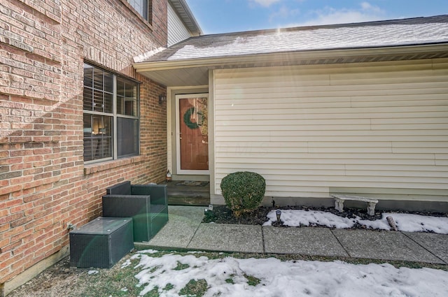 view of snow covered property entrance