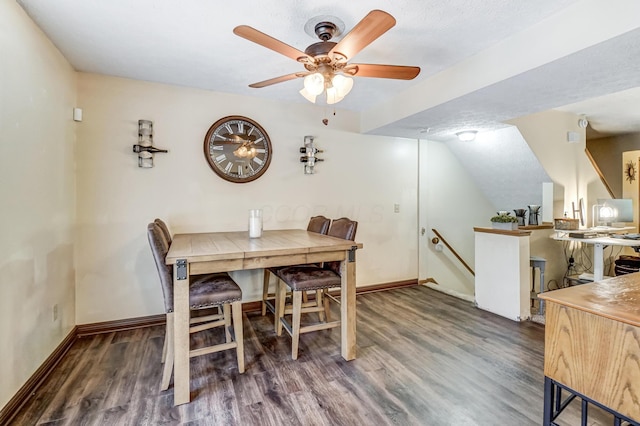 dining space featuring ceiling fan, a textured ceiling, and dark hardwood / wood-style flooring