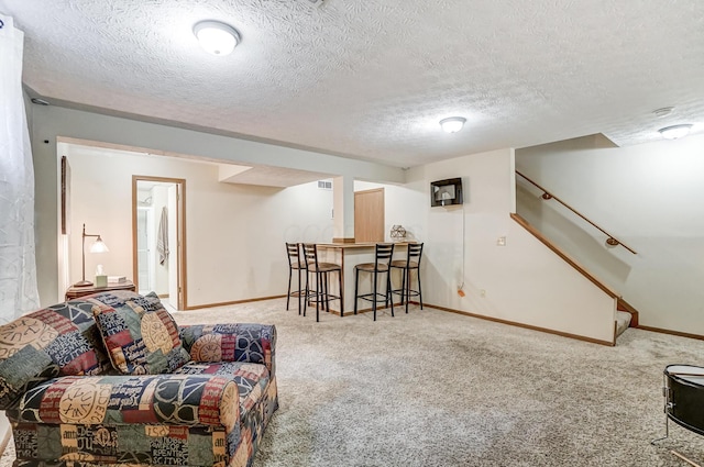 living room featuring light carpet and a textured ceiling