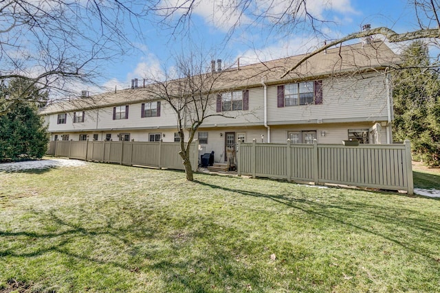 rear view of house with a yard