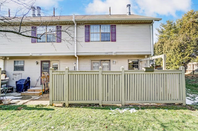 rear view of property with a yard