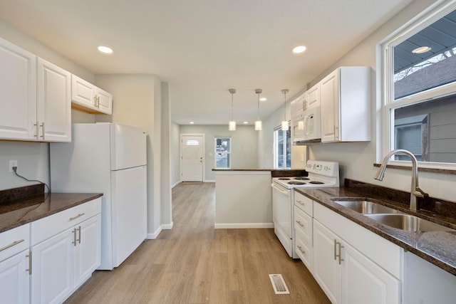 kitchen featuring sink, pendant lighting, white cabinets, and white appliances