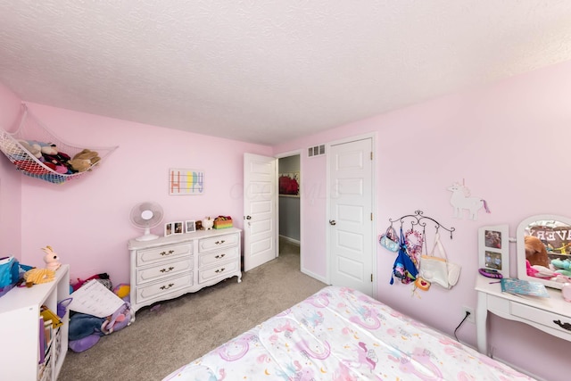 carpeted bedroom featuring a textured ceiling