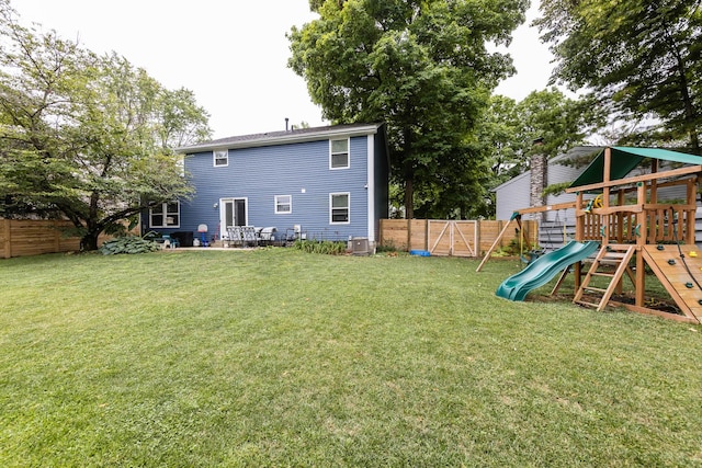 view of yard with central AC and a playground