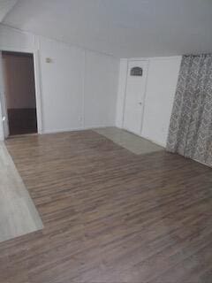 empty room with dark hardwood / wood-style floors