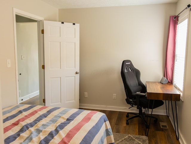 bedroom featuring dark wood-style floors, visible vents, and baseboards