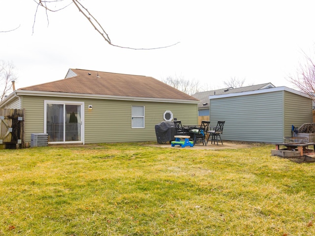 back of property featuring central air condition unit, a lawn, and a patio