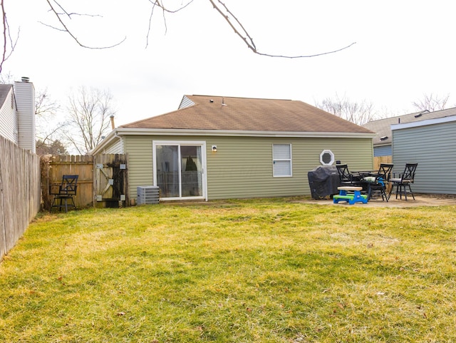 back of house with a patio, fence private yard, central air condition unit, a lawn, and a gate