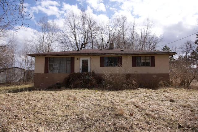 view of front of house featuring brick siding and stucco siding