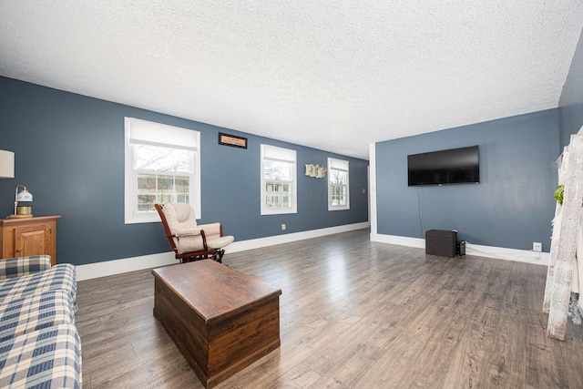 living room with dark wood-type flooring and a textured ceiling