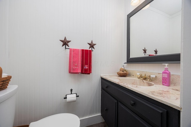 bathroom featuring vanity and toilet